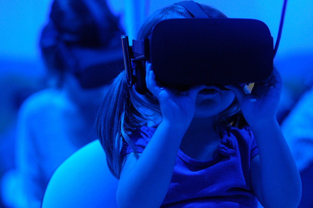 Kind sieht durch VR-Brille